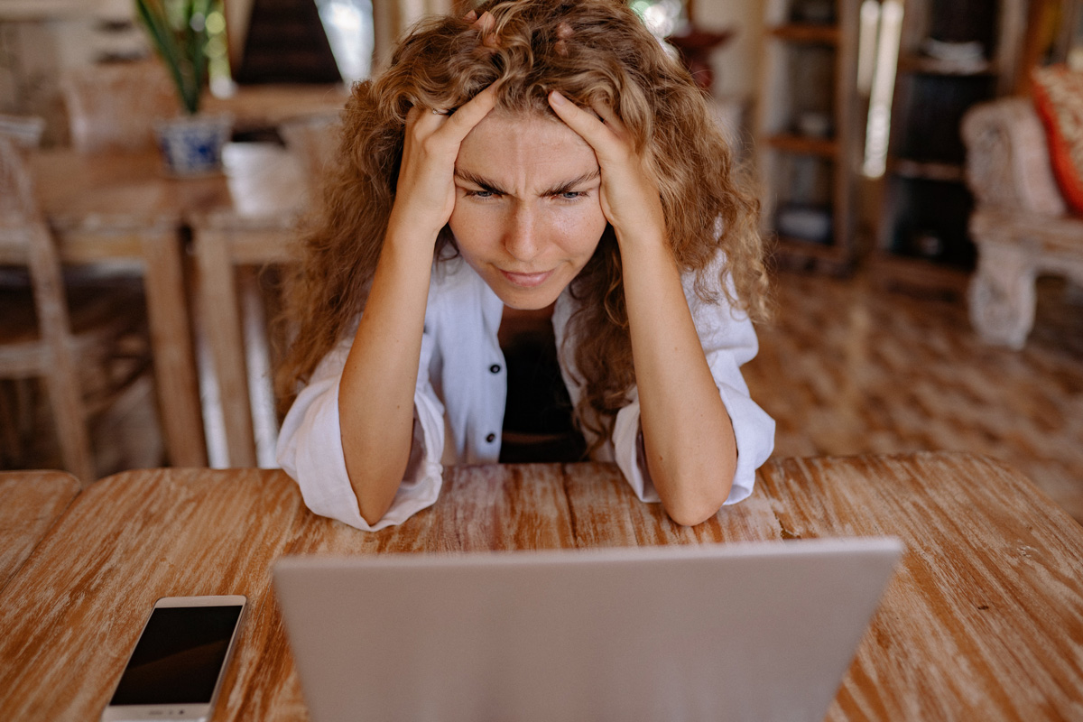 Woman at laptop looking frustrated